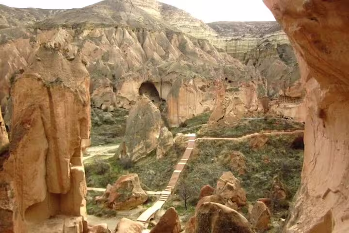 Tourists enjoying the unique rock formations of Cappadocia on a private tour from their hotel and ASR-NAV airport.