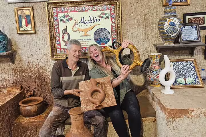 Visitors exploring Turkish pottery at Aladdin Ceramic Gallery during a private Cappadocia tour from hotel and airport.