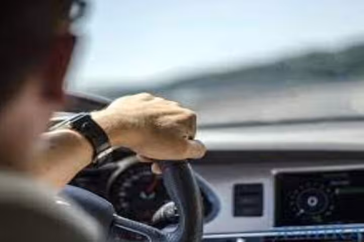 Professional driver steering a private car for Luxor Airport transfer, safe and comfortable ride to your hotel