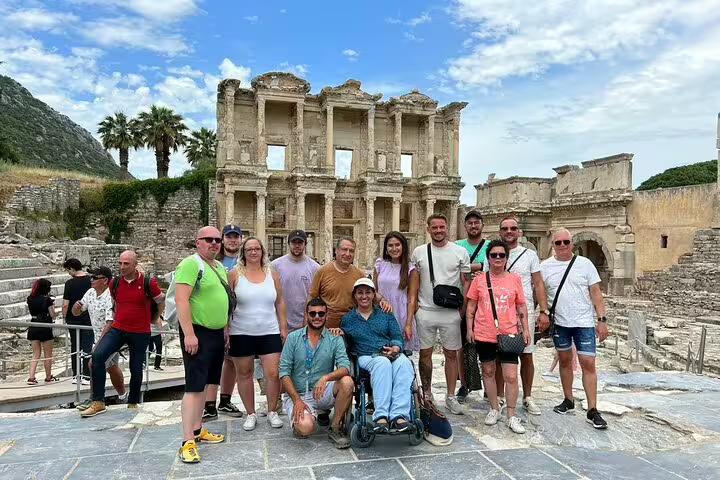 Group of tourists at the Celsus Library in Ephesus, enjoying a private tour with entry fees and lunch included.