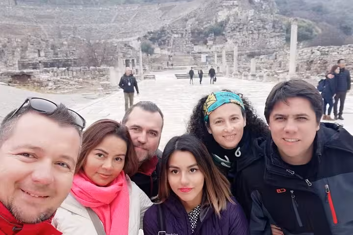Group selfie on private Ephesus tour for cruise passengers, Marble Street ruins and theater behind