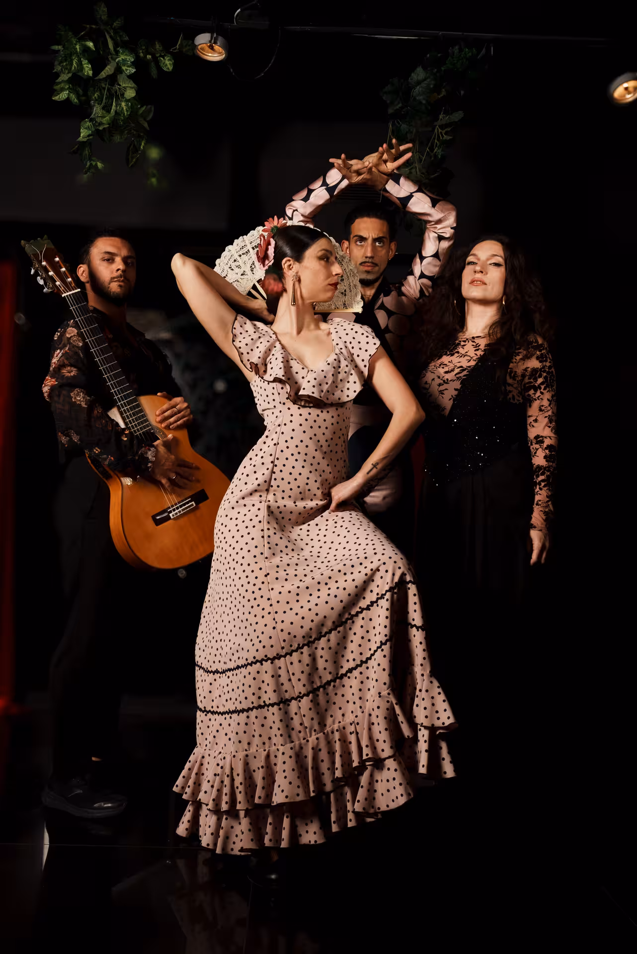 Dancers and guitarist performing vibrant flamenco at a private show, showcasing traditional Spanish culture.