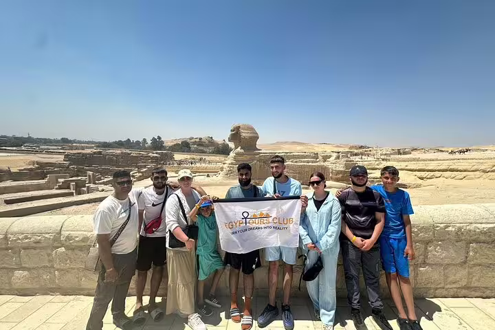 Group photo with tour banner at the Great Sphinx viewpoint, private Giza Pyramids and Sphinx tour Cairo