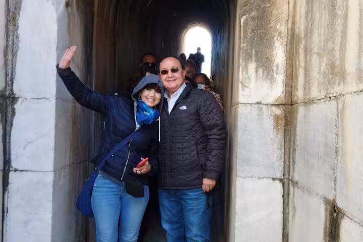 Guests on private Seven Churches of Revelation tour posing in stone passageway at an ancient biblical site