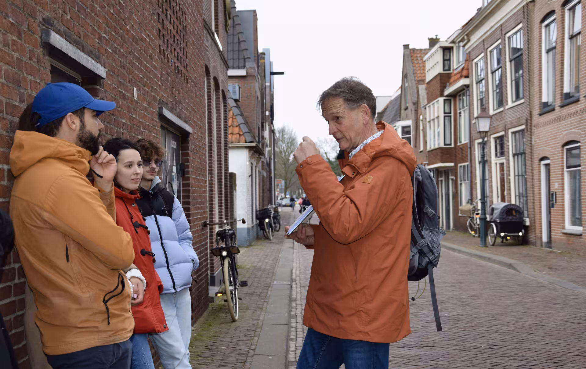 Local guide briefing guests on a private 2-hour Hoorn walking tour along historic Dutch canal street