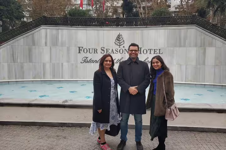 Guests pose by Four Seasons Hotel Istanbul fountain, ideal stop on a private flexible Istanbul city tour