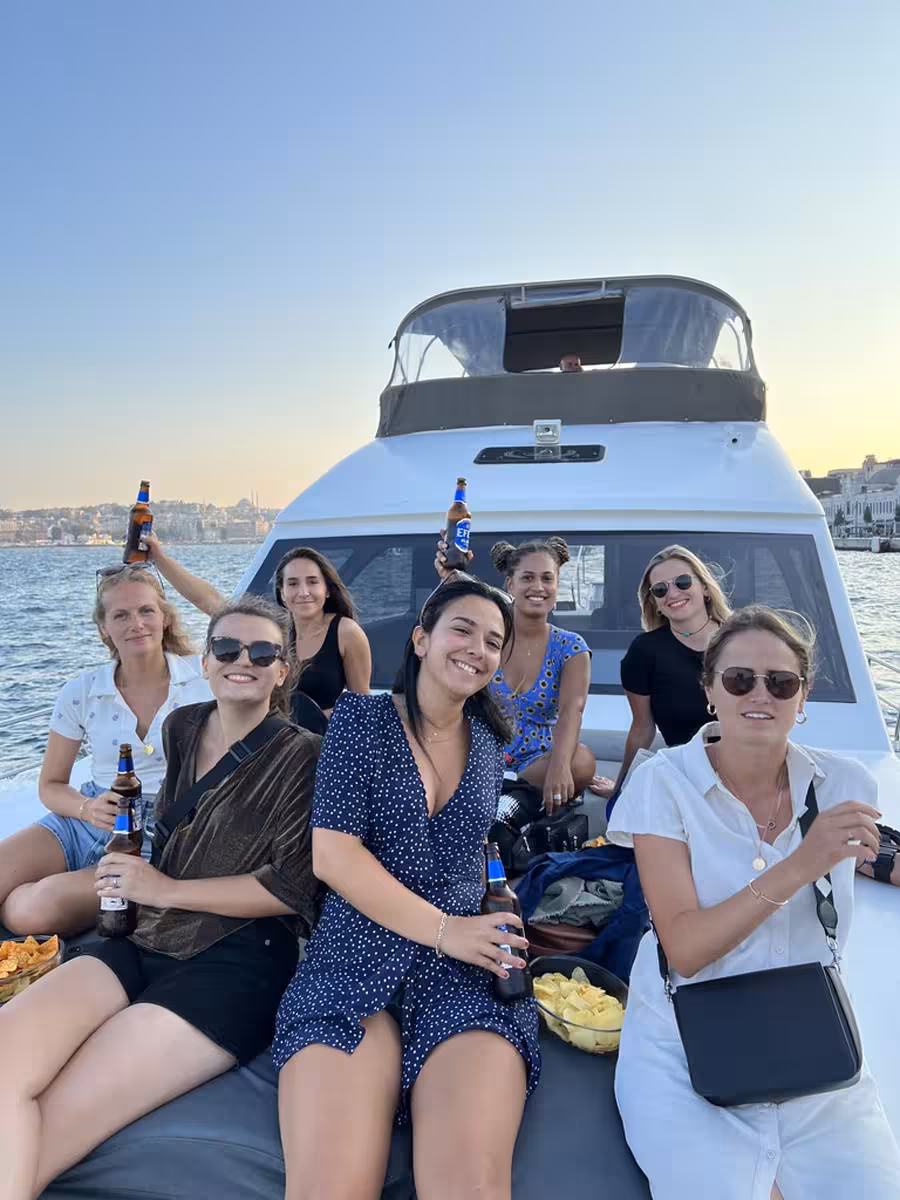 Friends toast on a private Istanbul yacht cruise on the Bosphorus, perfect for a swimming tour at sunset