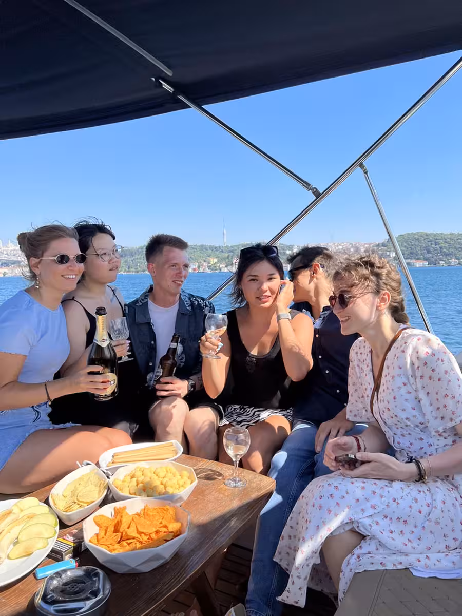 Friends enjoying snacks and drinks on a private Istanbul yacht swimming tour on the Bosphorus with sea views