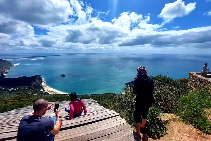 Tourists enjoy breathtaking ocean views from a scenic lookout during a private 4x4 Jeep and beach picnic tour in Arrábida, Sesimbra-Lisbon.