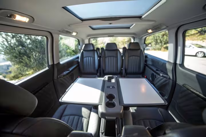 Spacious private minivan interior with tables and skylights for Best of Athens and Ancient Corinth tour