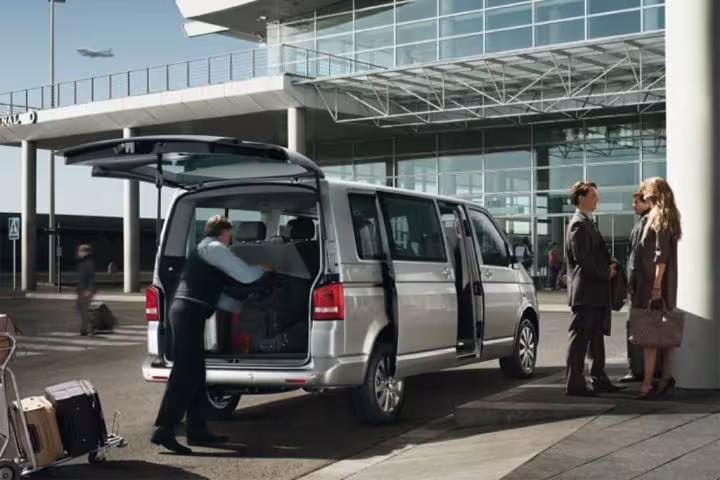 Private minivan transfer at Rome airport, chauffeur loading luggage for comfortable Roma to Sorrento journey