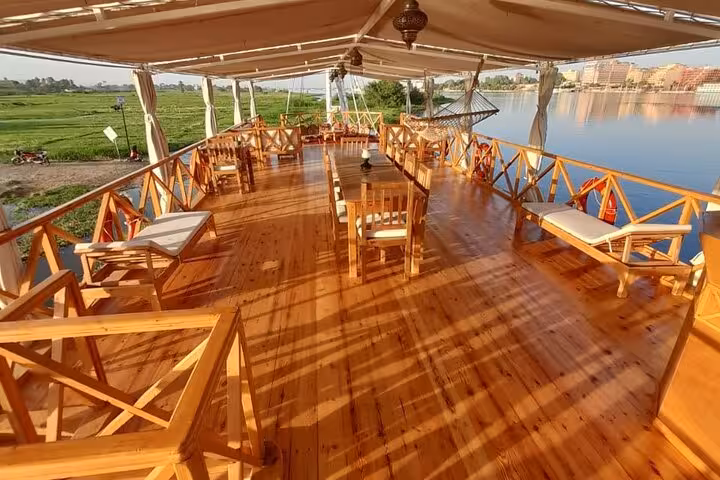 Spacious wooden sundeck with loungers on private Nile cruise, 7 days 6 nights Aswan to Luxor route