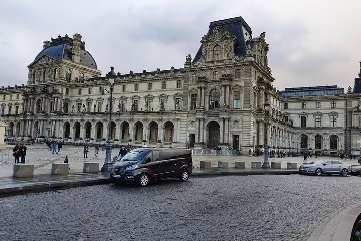 Private driver van parked by the Louvre Museum, ideal for a Paris half day private sightseeing tour by car