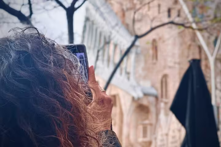 Participant snapping a detailed photo of historic architecture on a private phone photography tour in the old town.