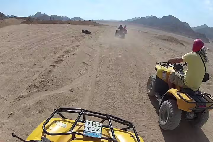 Private quad biking from Sharm El Sheikh across Sinai desert tracks, riding ATVs with mountain views