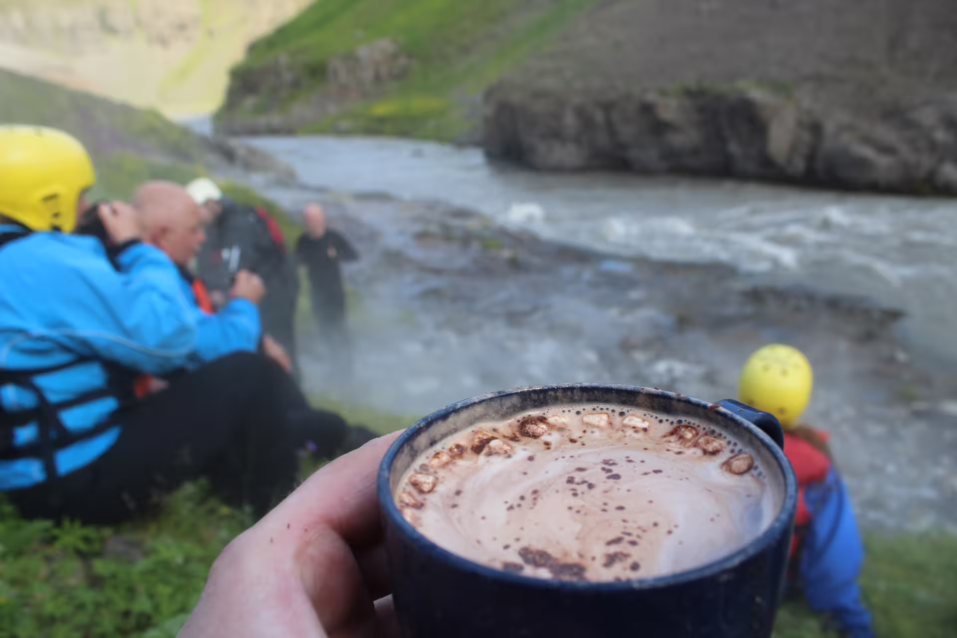Enjoy a cozy hot drink by the West Glacial River during a private rafting adventure with pickup from Akureyri.