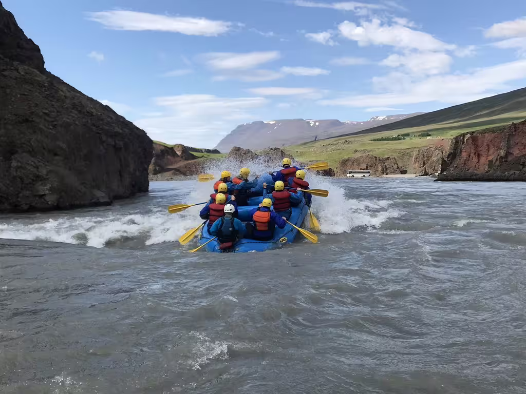Adventurers enjoy a thrilling private rafting experience on West Glacial River, surrounded by stunning Icelandic landscapes near Akureyri.
