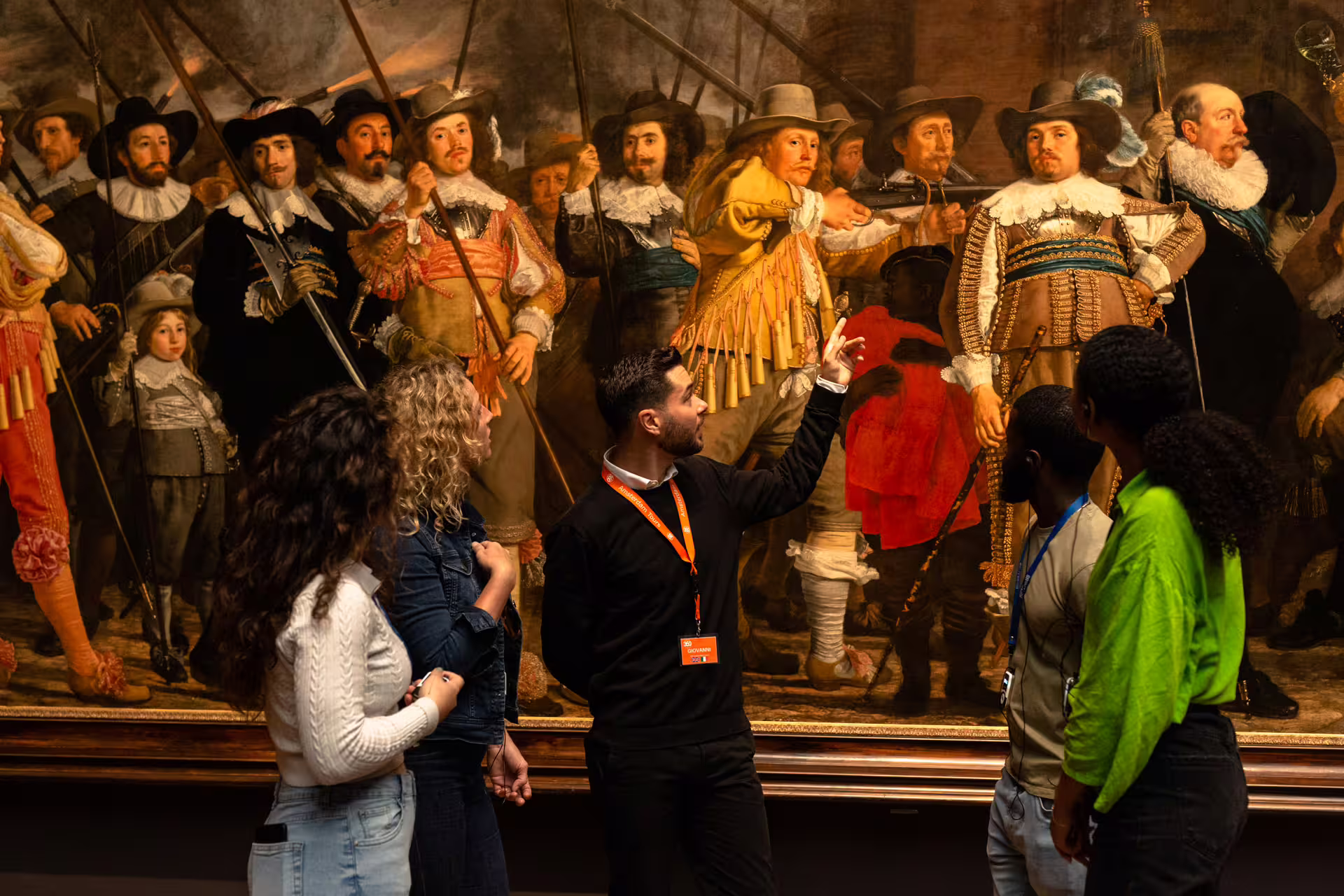 Visitors engage with a guide during a private Rijksmuseum tour, exploring Dutch masterpieces and vibrant historical art.