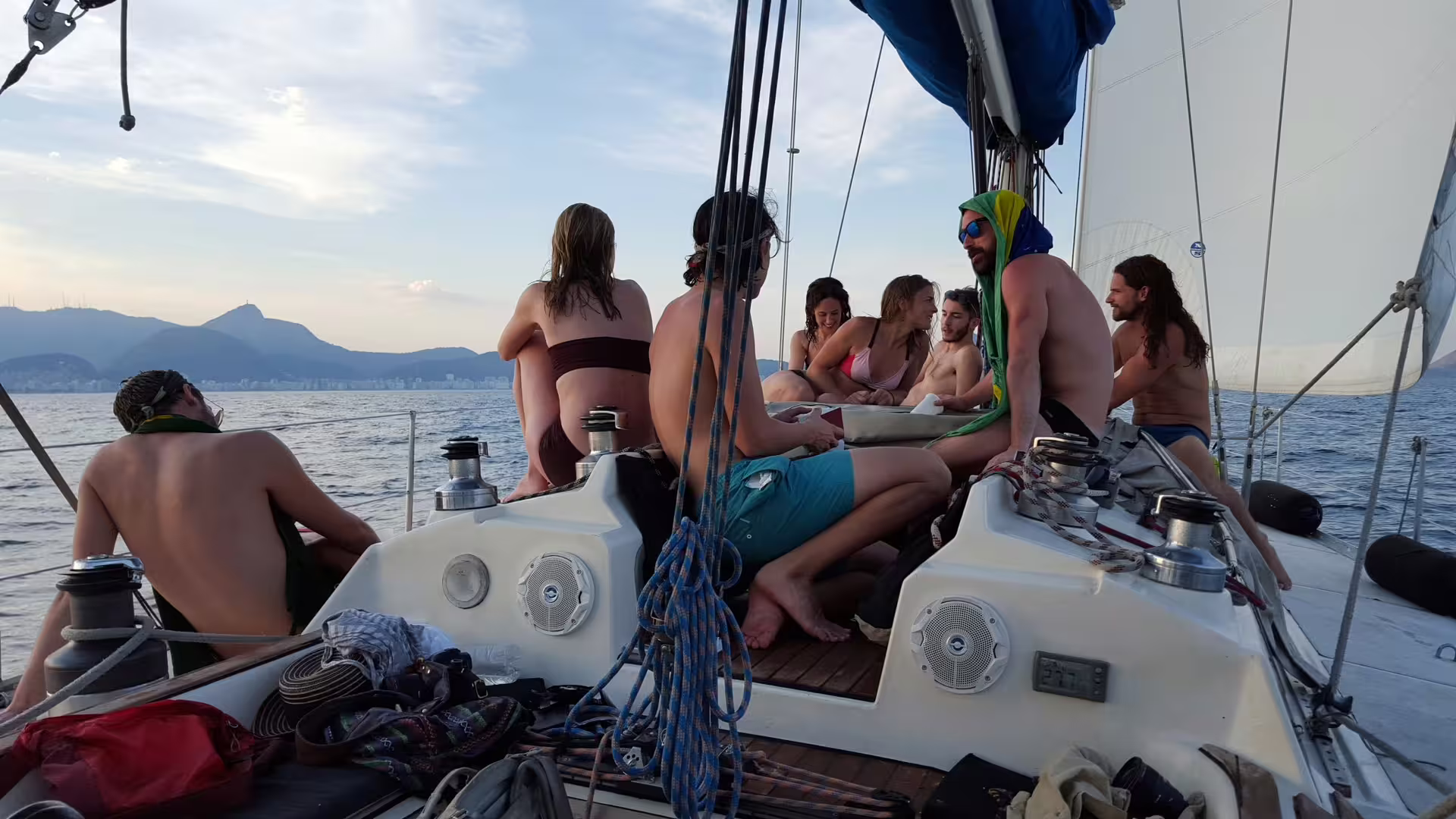 Friends relaxing and enjoying a sunset view on a private sailing tour aboard MAKANI MAIKAI yacht.