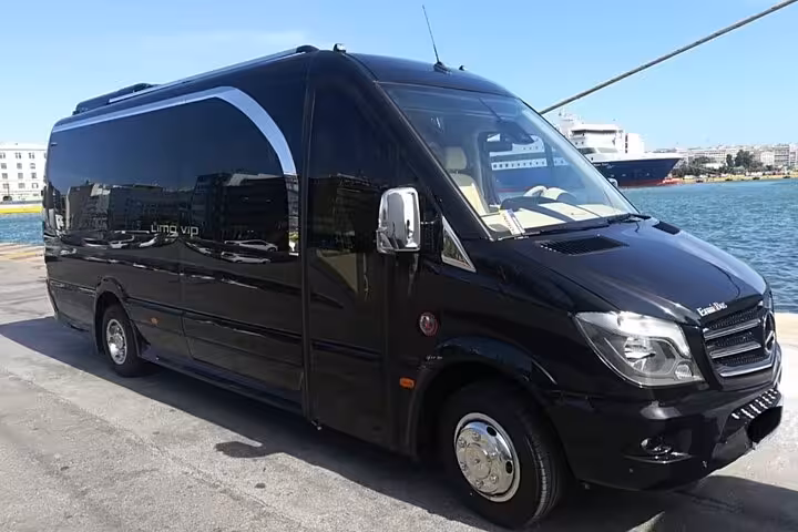 Luxury black Mercedes minibus for private 3-day Santorini tour with transfer included, parked by the port