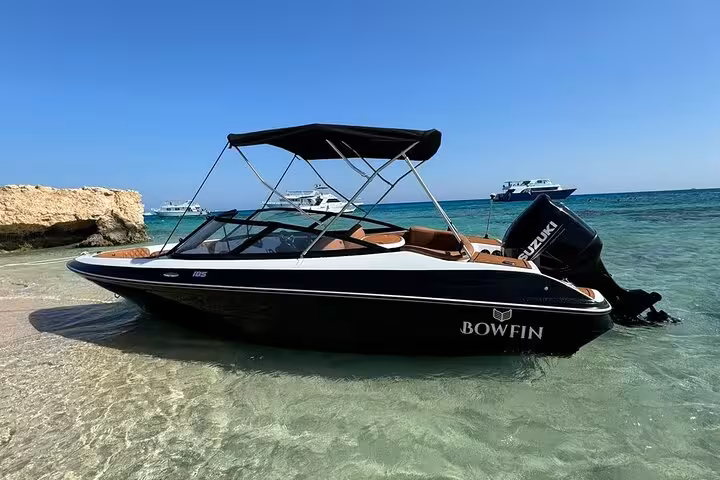 Private speedboat on a Hurghada beach, ready for Red Sea dolphin watching and snorkeling adventure