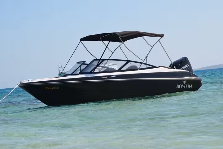 Private speedboat anchored in clear Red Sea water for Mahmya Island day trip with lunch from Hurghada