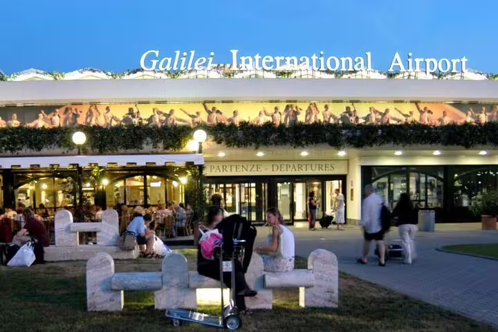 Pisa International Airport bustling with travelers, ideal for private transfers from Florence to Pisa Airport.