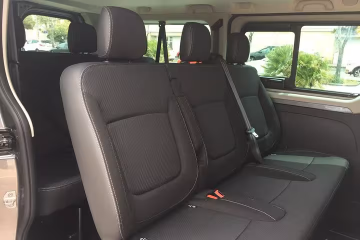 Spacious black leather rear seats in private transfer van for Marseille to Nice chauffeur service