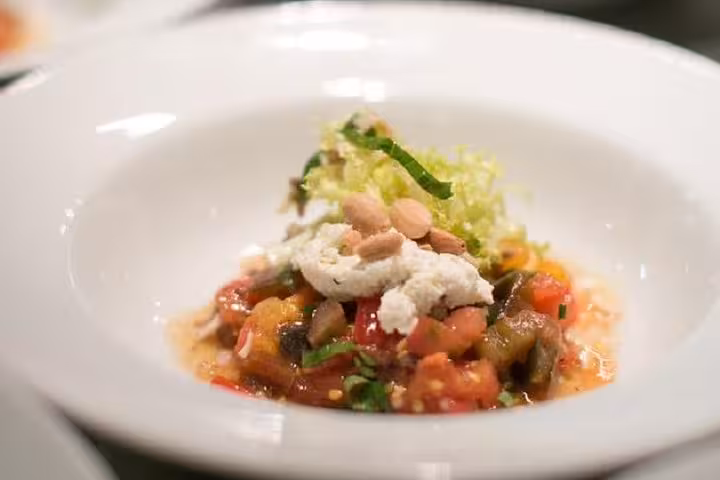 Plated Provençal ratatouille with fresh cheese and almonds from an Avignon cooking workshop with a chef