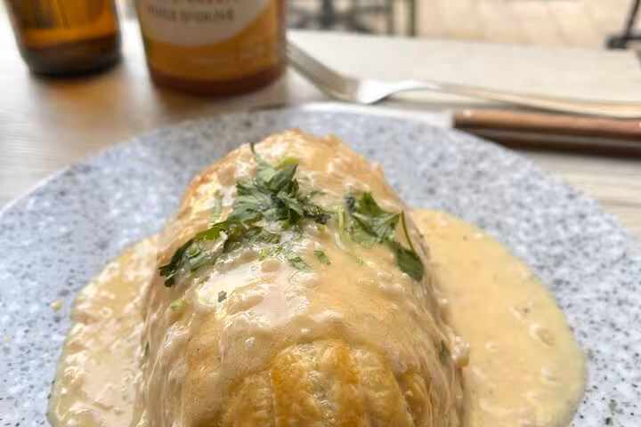 Close-up of a creamy Provençal seafood dish plated after a Marseille cooking class with a local chef