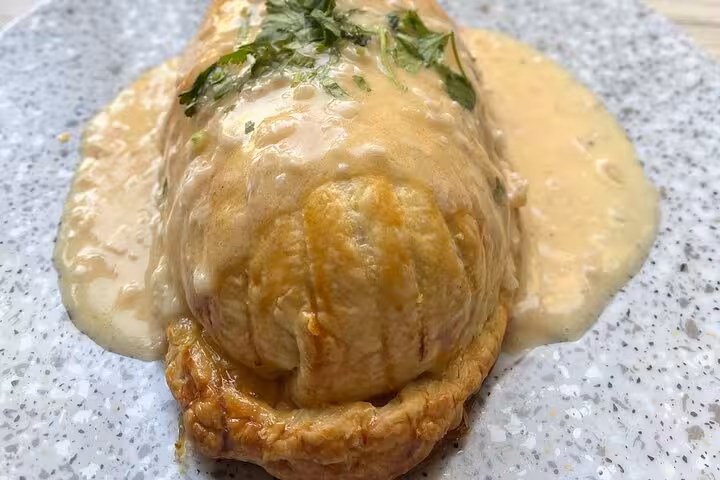 Homemade Provençal stuffed pastry with creamy sauce, prepared in a Marseille cooking workshop with local chef