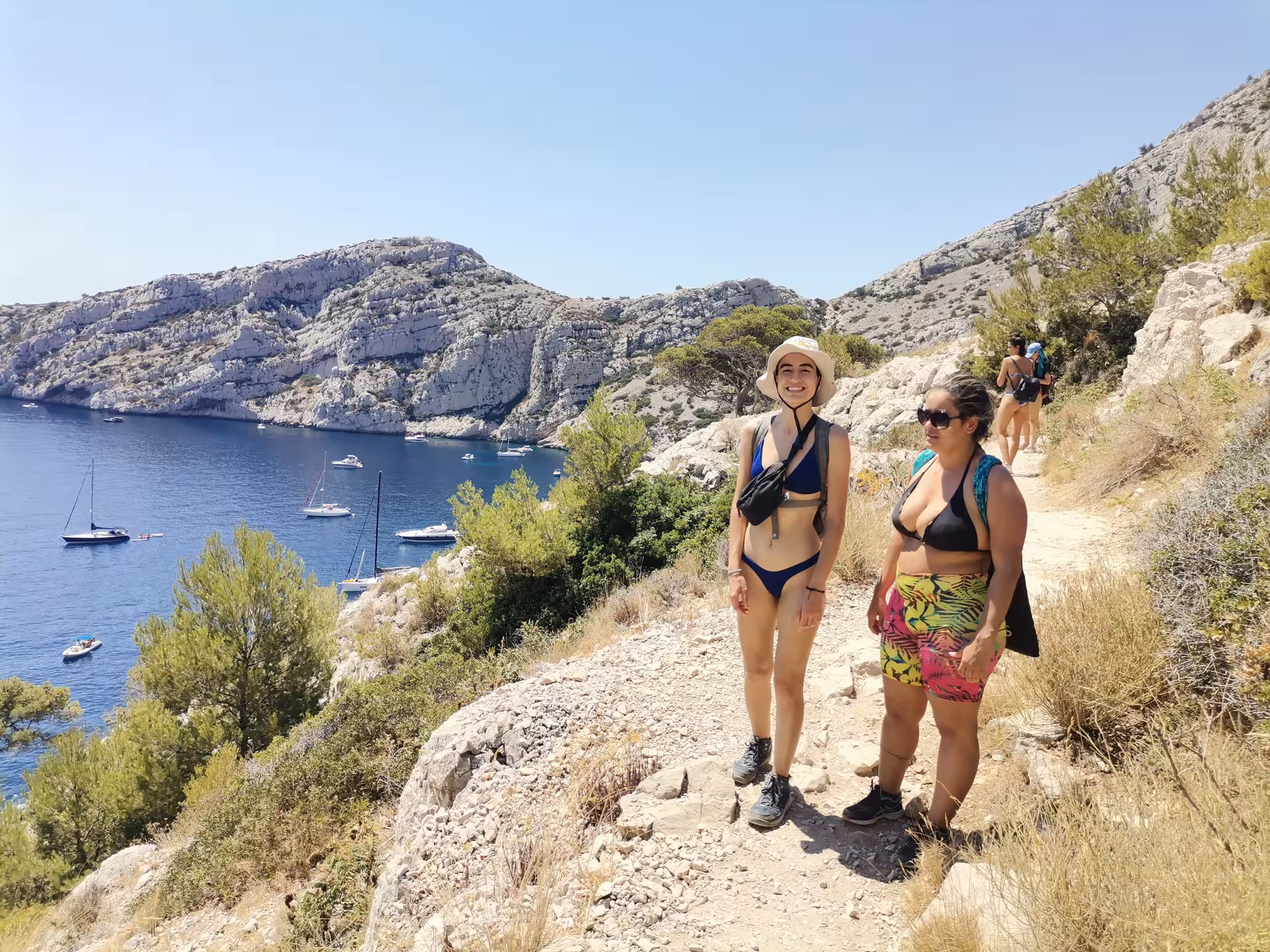 Coastal hikers on the Calanques trail above turquoise coves near Marseille, Provence 7-day hiking getaway