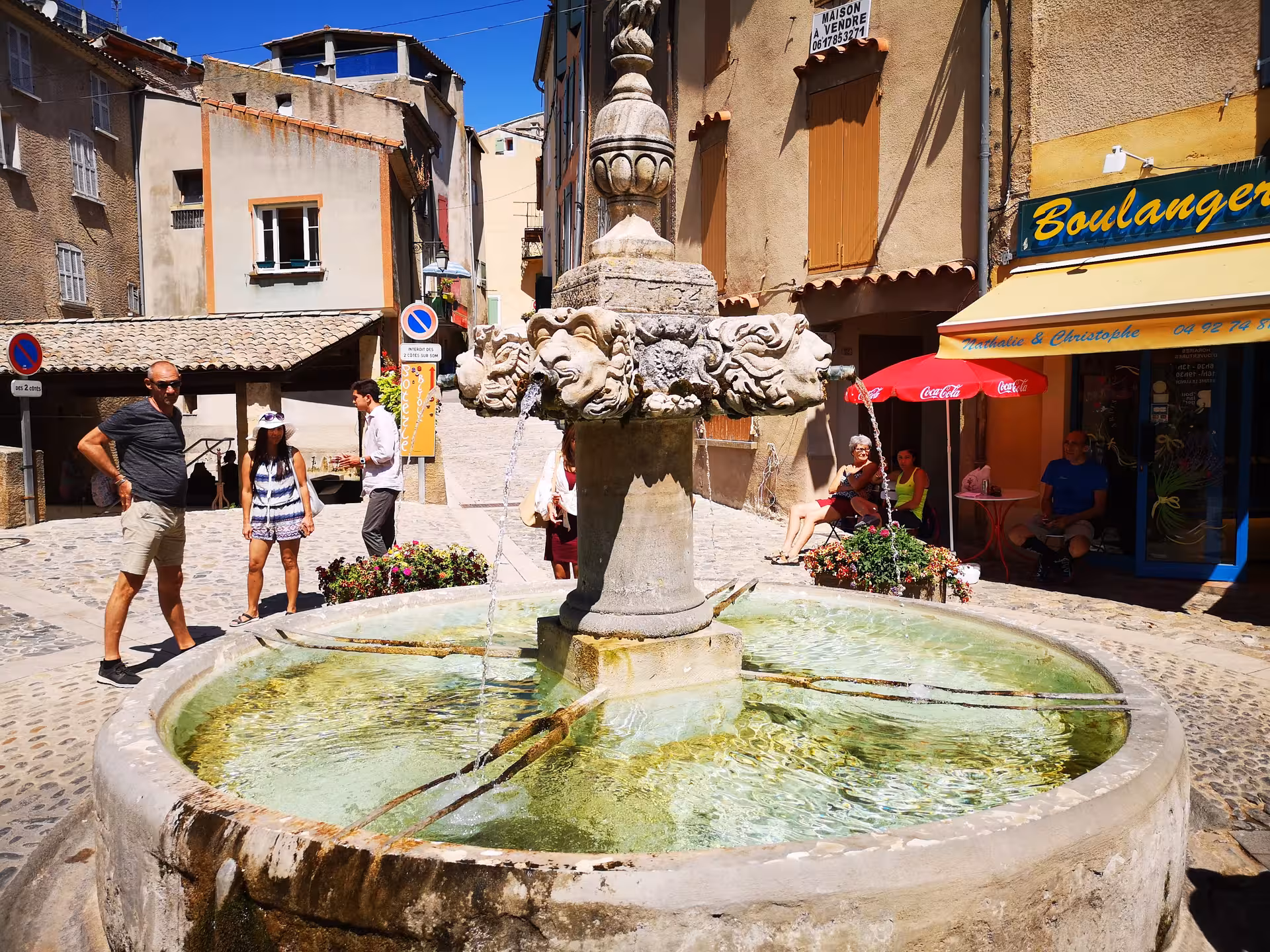Stone fountain in a Provence village square, a scenic stop on a Lavender Private Day Trip from Avignon
