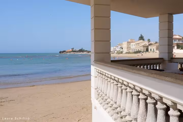 Scenic view of Punta Secca beach with charming seaside architecture from Montalbano series tour in Sicily.