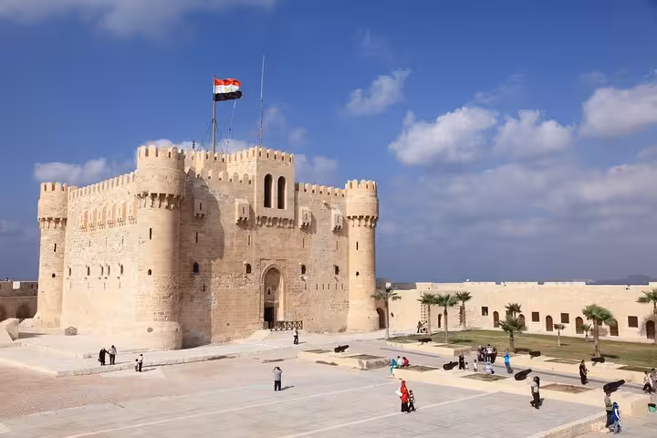 Panoramic view of Qaitbay Citadel in Alexandria with Egyptian flag, highlight of full-day tour from Cairo