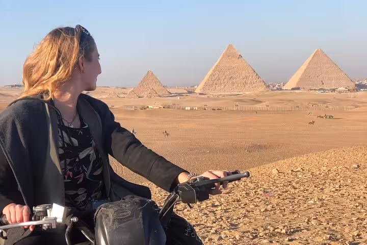 Traveler on quad bike in Giza desert with Great Pyramids view, ATV tour with transfers and drinks
