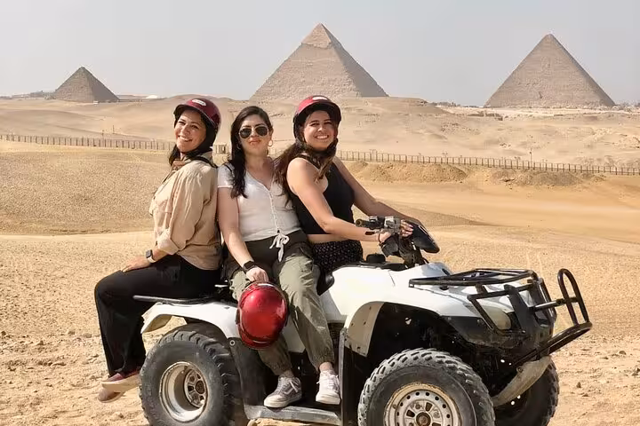 Friends on quad bike ATV safari with Giza Pyramids backdrop, Cairo desert adventure tour before Nile dinner cruise
