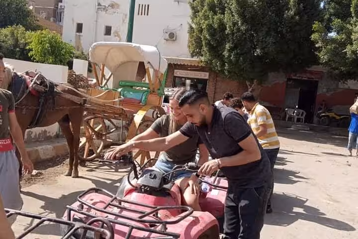 Guests getting safety briefing on quad bikes in Cairo, part of camel ride, lunch and shopping combo tour