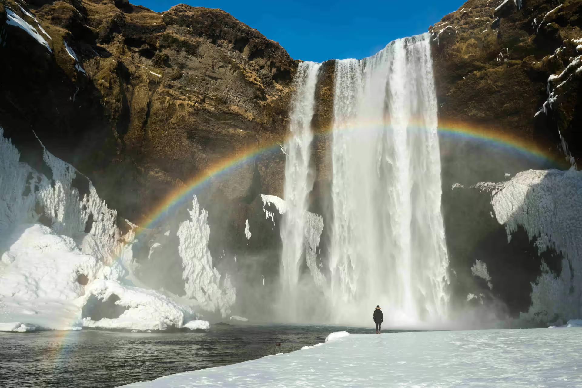A rainbow formed at the basin of Skogarfoss