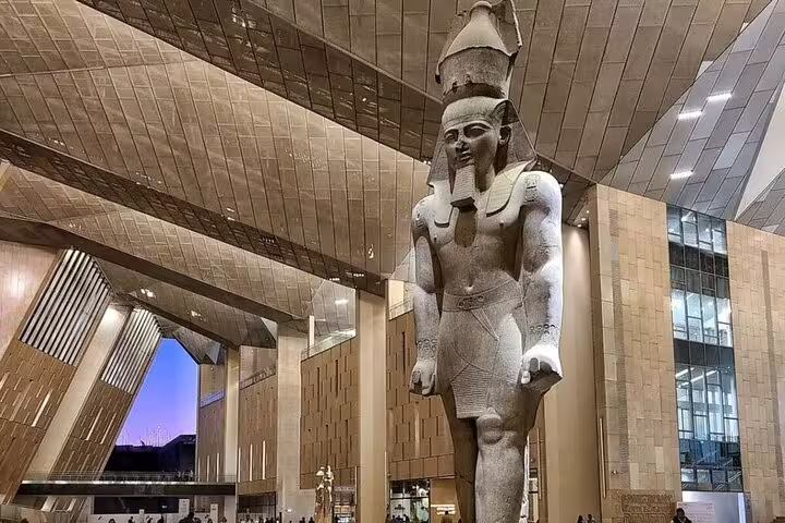 Colossal Ramses II statue in the Grand Egyptian Museum atrium on a 3-hour GEM tour in Giza, Cairo