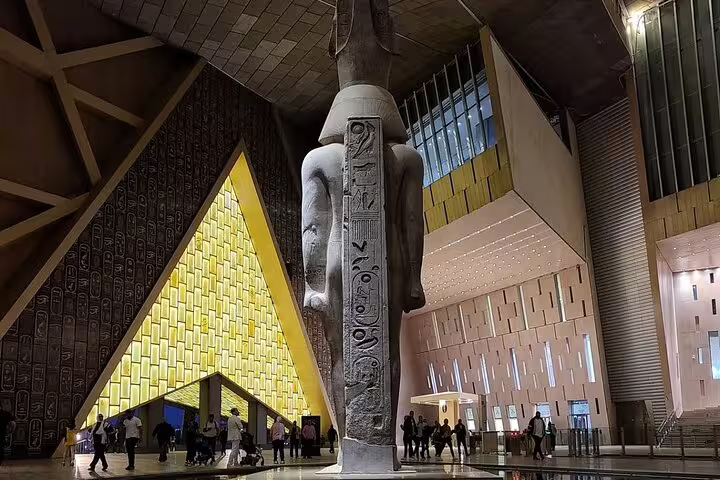 Back view of Ramses II statue with hieroglyphs inside Grand Egyptian Museum, highlight of 3-hour GEM tour