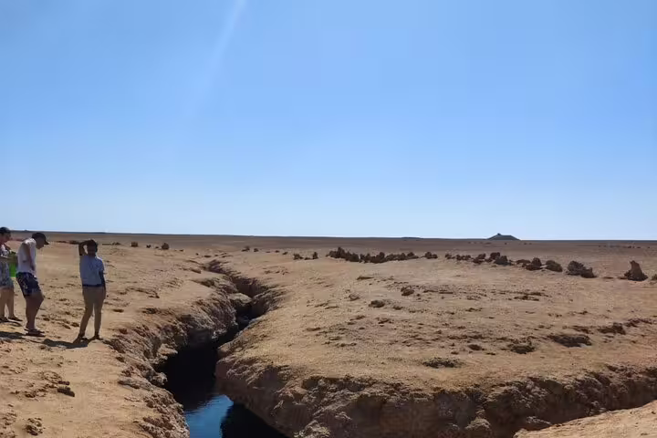 Visitors by desert water crack at Ras Mohammed National Park, photo stop on half-day bus tour from Sharm El Sheikh