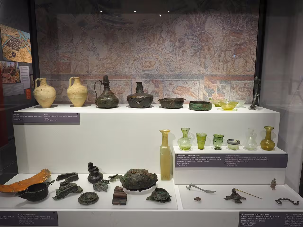 Everyday Roman artifacts and glassware exhibit at Ravenna Classis Museum with mosaic backdrop on combo visit