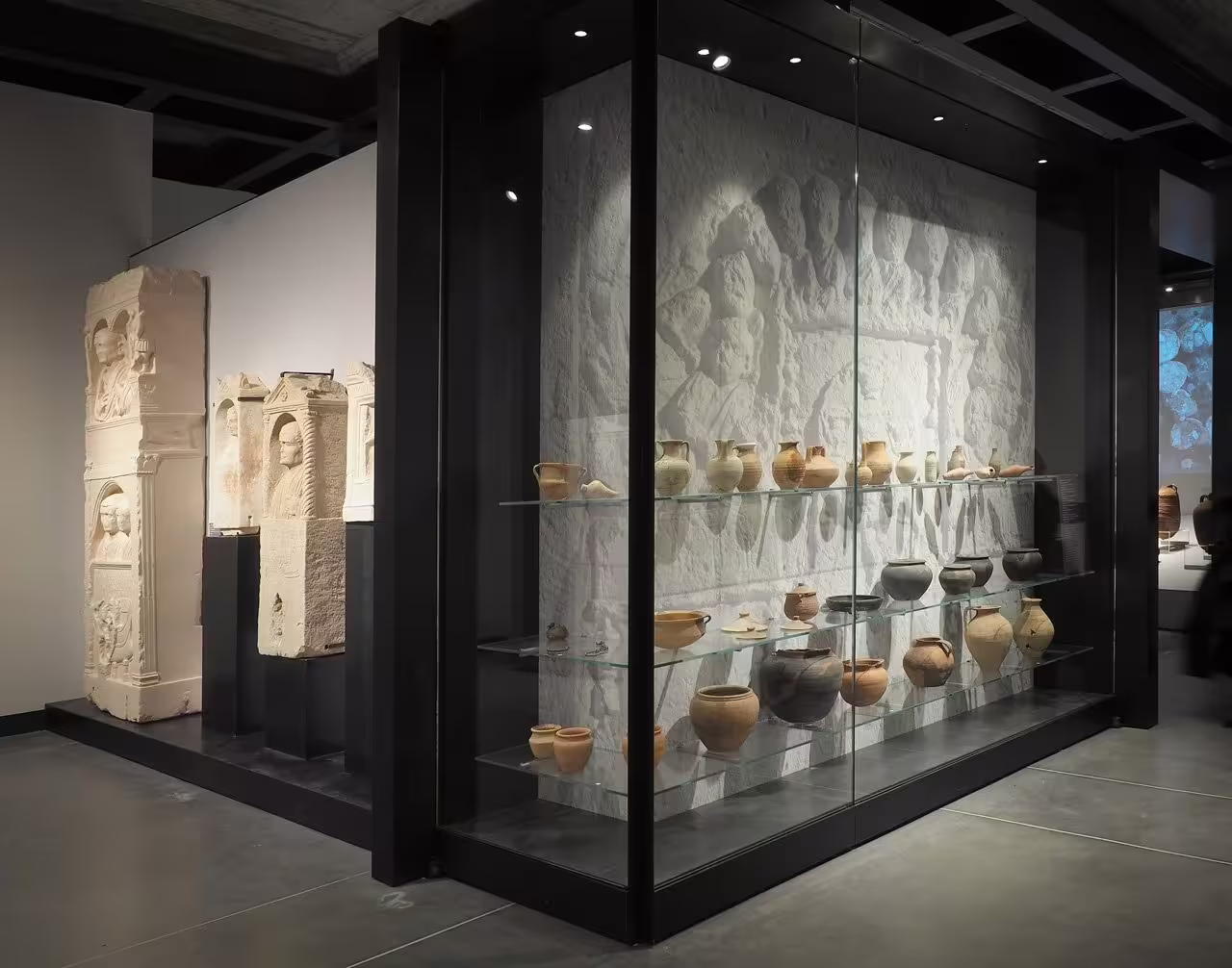 Glass display of Roman pottery and stone carvings at Classis Museum, part of Ravenna combo museum and basilica visit