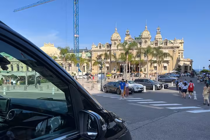 Premium black van in vibrant urban setting, perfect for seamless Ravenna cruise terminal to Bologna Airport transfer.