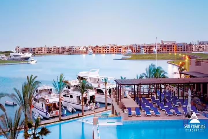 Marina-side Red Sea hotel pool with yachts and loungers, ideal beach break on Cairo and Red Sea 4-day trip