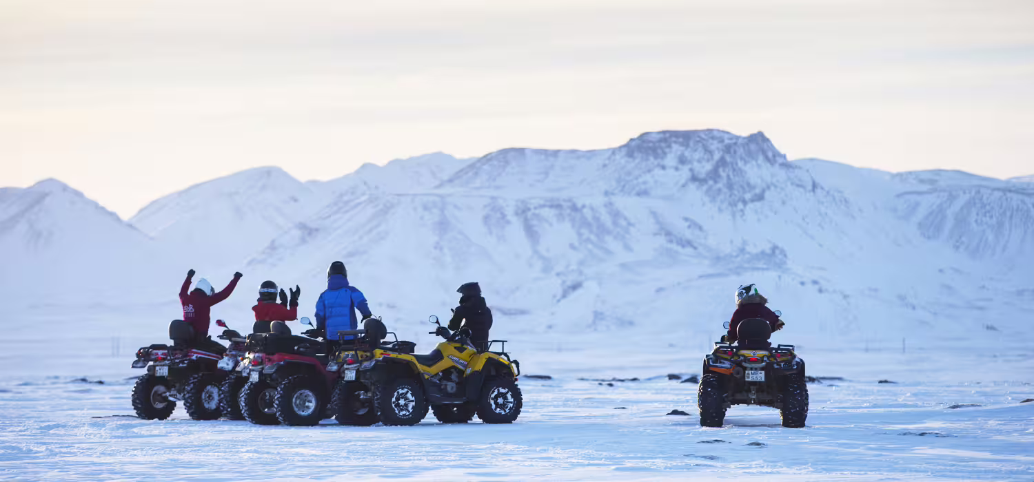 ATV riders explore snowy landscapes with stunning mountain views on a thrilling 1-hour Reykjavik Peak adventure tour.