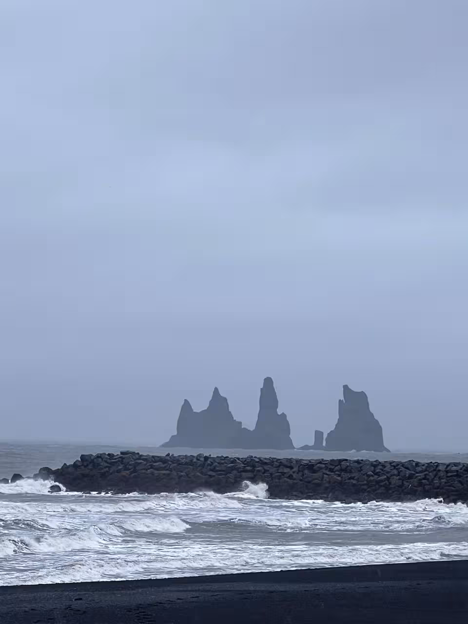 Wide view of Reynisdrangar sea stacks from Reynisfjara black sand beach, South Coast private tour Reykjavik