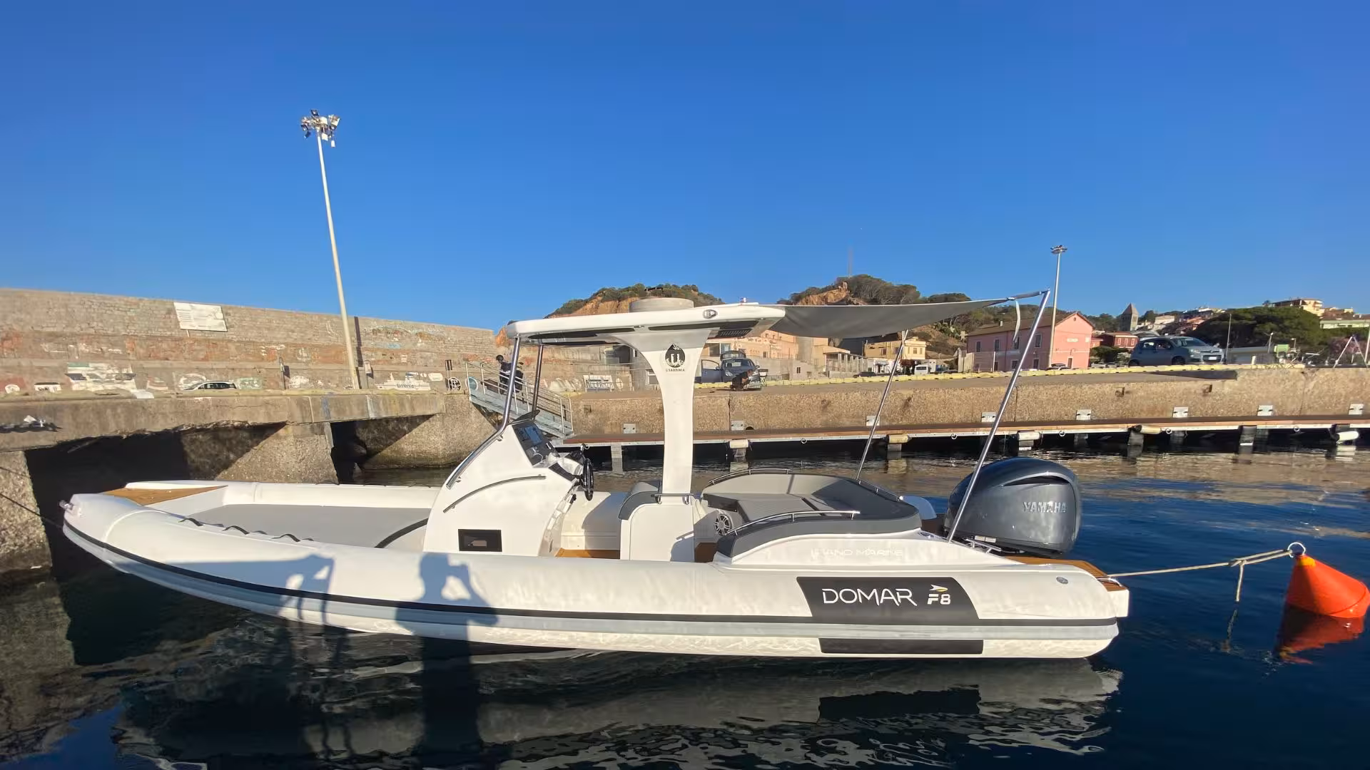 Sleek RIB boat docked at Arbatax harbor, ready for a scenic tour to Cala Mariolu and Cala Goloritzè.