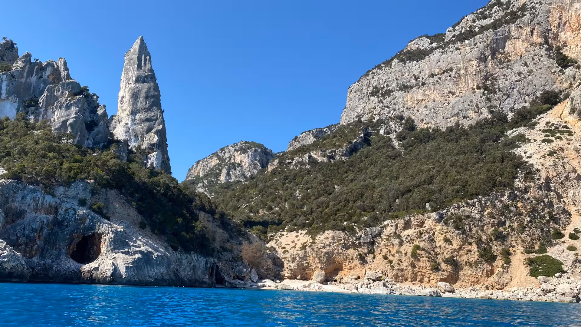Majestic rock formations and turquoise waters at Cala Goloritzè, Sardinia, viewed from a RIB boat.